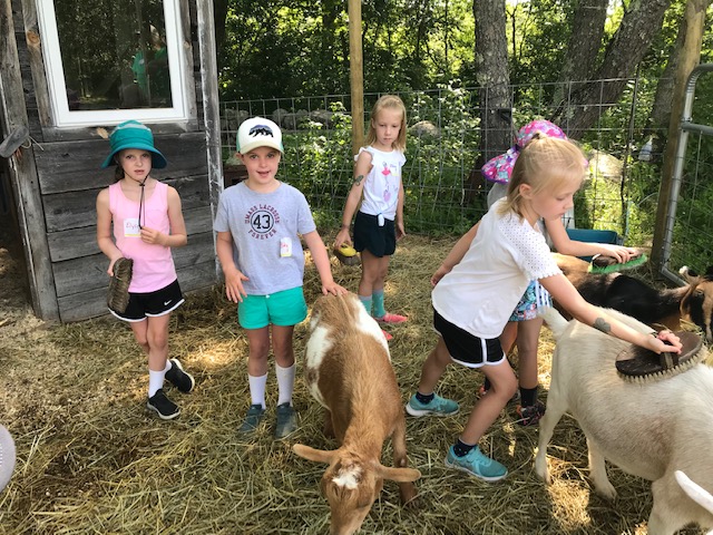 girls proudly displaying the harvest